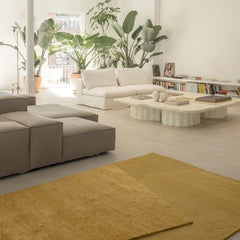 nanimarquina oblique rug amber by matthew hilton in loft with sofas and large coffee table