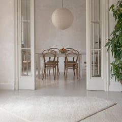 nanimarquina oblique rug ivory by matthew hilton in Barcelona apartment with thonet bentwood chairs and rice paper pendant light