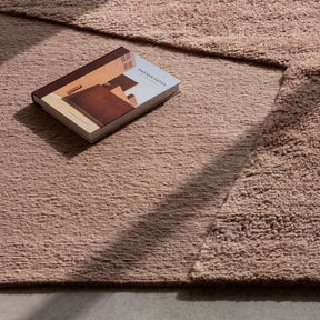 nanimarquina oblique rug pink quartz by matthew hilton with book and sunlight