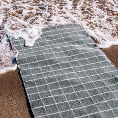 nanimarquina Tiles 1 runner on sandy beach by the sea