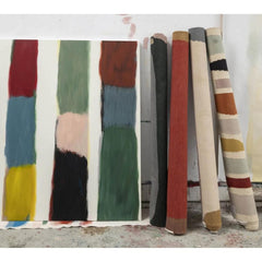 naimarquina Tones Kilim collection rolled up beside oil painting by Claudia Valsells
