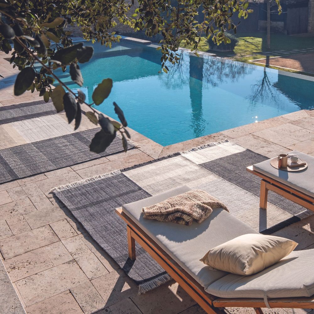 Nanimarquina Tres Outdoor Rugs Black by Pool with Chaise Lounge Chairs