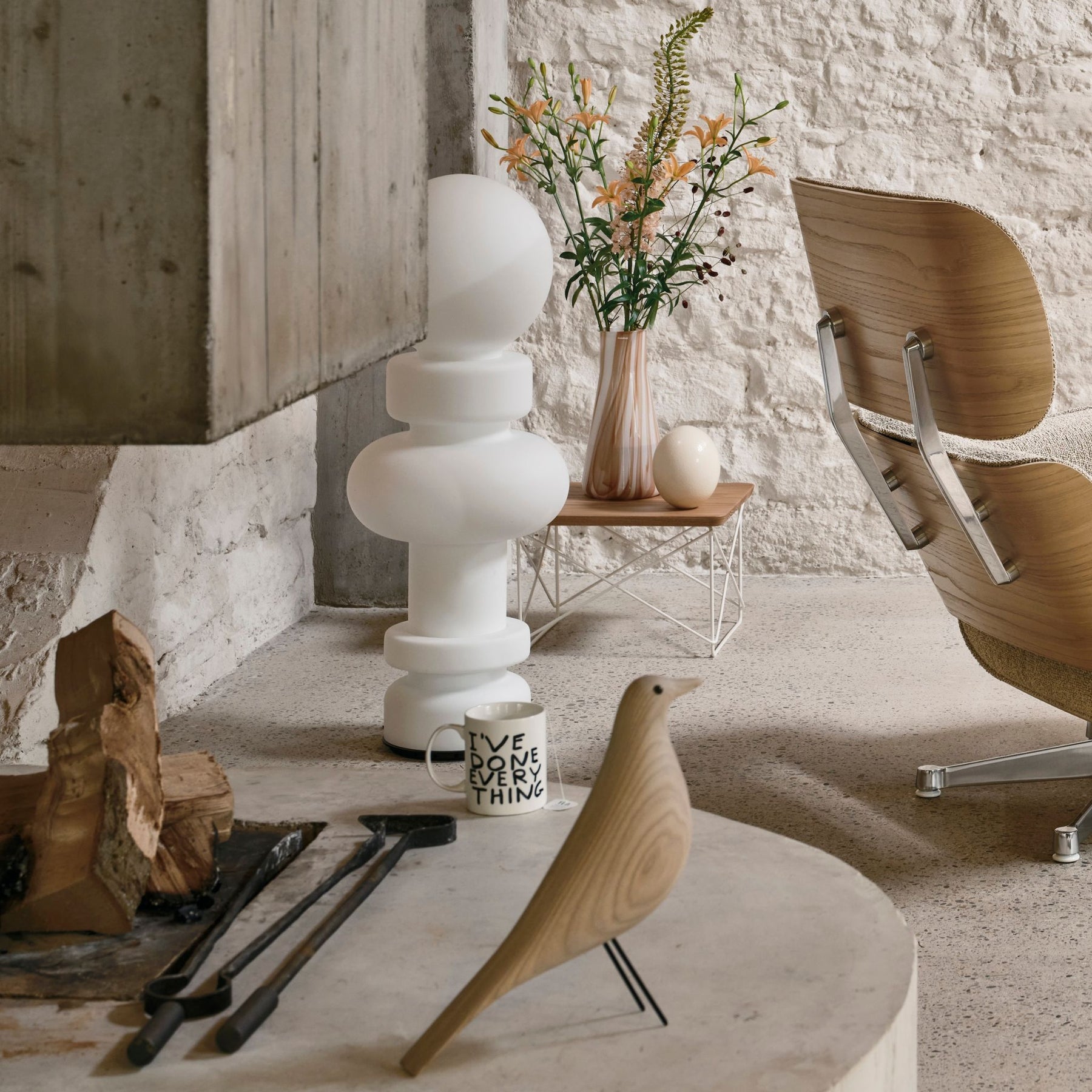 Vitra Eames House Bird White Ash on Hearth with Mug and Flowers