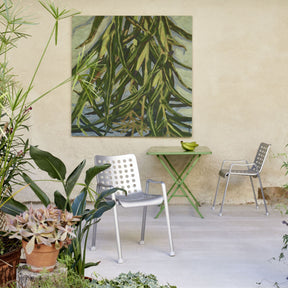 Vitra Landi Chairs by Hans Coray Outdoors with Green Bistro Table and Green Bananas