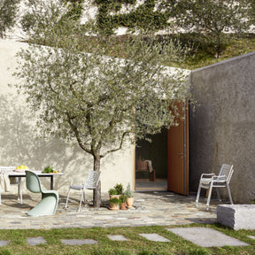 Vitra Landi Chairs by Hans Coray Stacked Outside in Stone Courtyard