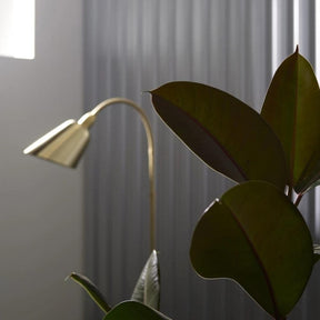 Arne Jacobsen Brass Bellevue Floor Lamp in Room with Plant And Tradition