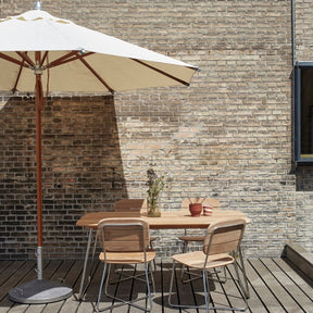 Atlantis Round Umbrella with Capri Umbrella Foot and Lilium Chairs and Table by Skagerak