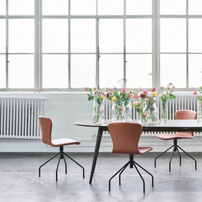 bruunmunch PLAYSwing Dining Chairs Cognac Leather in Copenhagen Loft with Smoked Oak PLAY Lame Dining Table