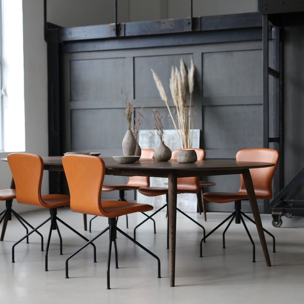 bruunmunch PLAYSwing Dining Chairs Cognac Leather in Industrial Loft with PLAY Lame Smoked Oak Dining Table