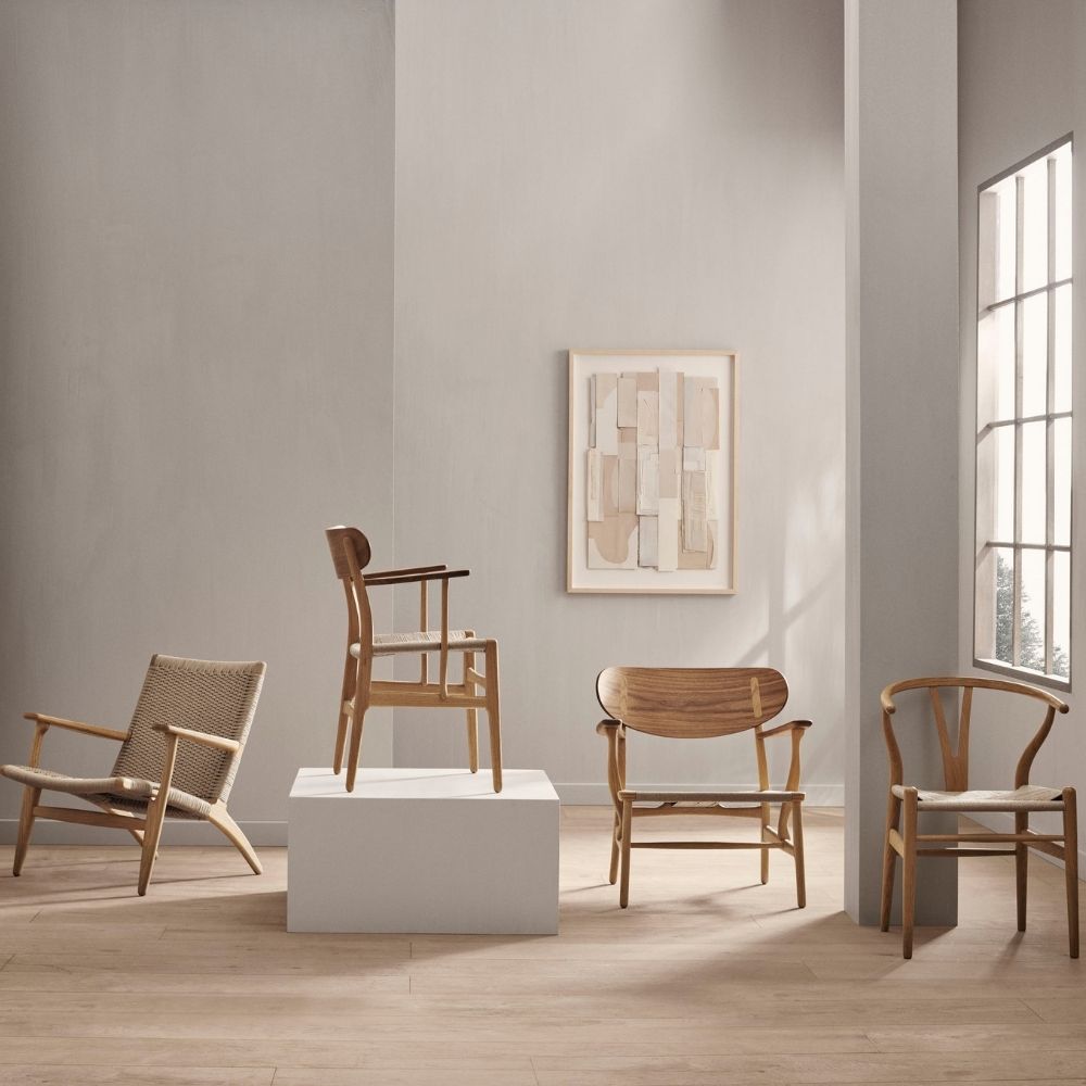 Wegner CH22 Lounge Chair in room with CH25, CH26, and CH24 Chairs