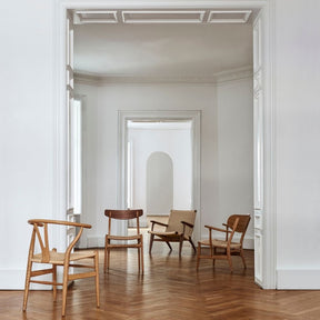 Carl Hansen Wegner CH22 Lounge Chair with other icons in Copenhagen Apartment