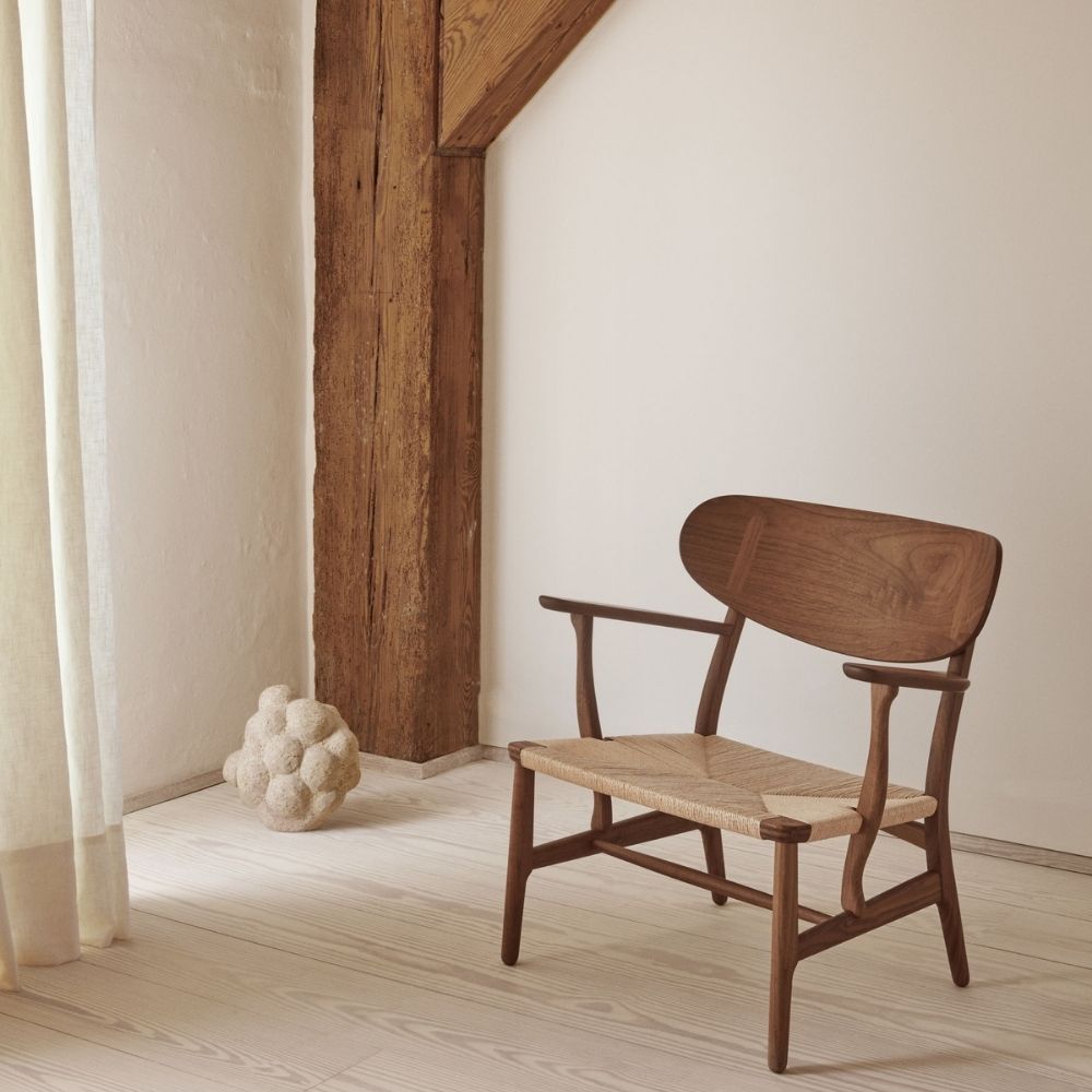 Wegner CH22 Lounge Chair in Walnut by Carl Hansen and Son in Room