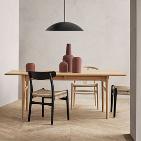 Wegner CH23 Dining Chair Black Oak and CH24 Wishbone Chair in room with CH327 Dining Table Styled