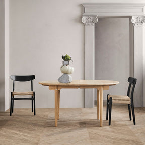 Wegner CH23 Dining Chairs Black Oak with Natural Papercord in room with CH337 Dining Table Oak White Oil