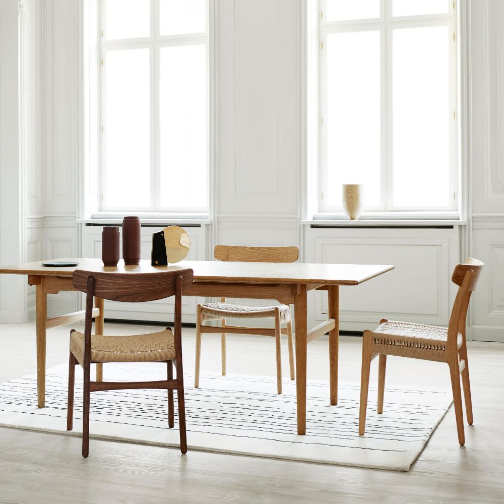 Carl Hansen Wegner CH23 Oak and Walnut Dining Chairs in Room with Dining Table and Naja Utzon Popov Woodlines Rug