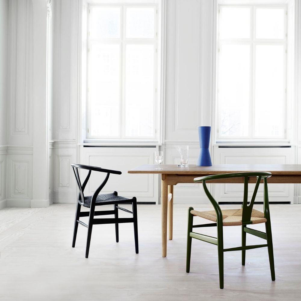 Carl Hansen Wegner CH327 Dining Table in calm white dining room with painted wishbone chairs