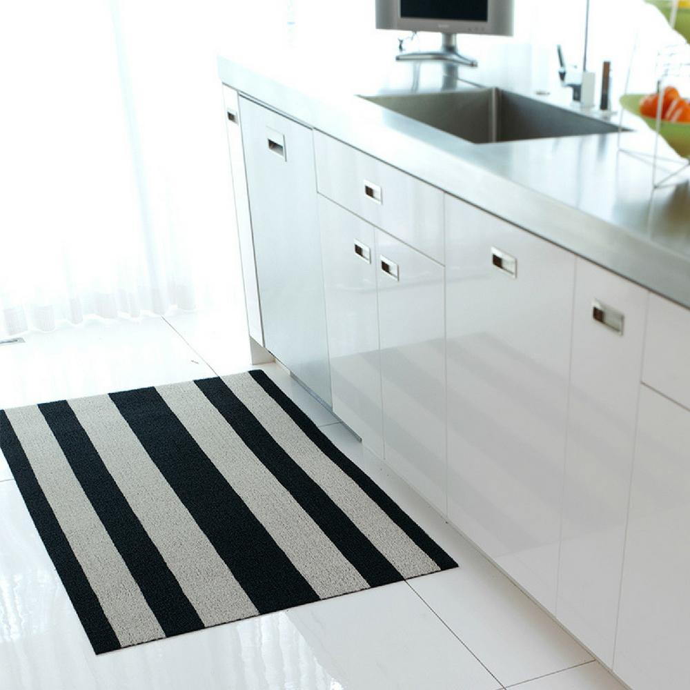 https://www.paletteandparlor.com/cdn/shop/products/chilewich-bold-stripe-indoor-outdoor-shag-mat-black-white-in-kitchen_1000x.jpg?v=1595787615