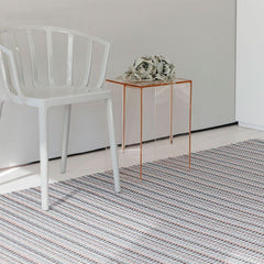 Chilewich Heddle Floormat Dogwood in room with Kartell Venice Chair