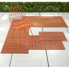 Chilewich Skinny Stripe Rug Outdoors with Bend Lucy Chair in Orange