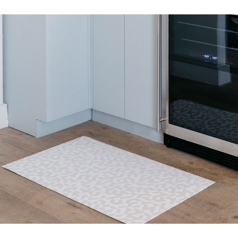 https://www.paletteandparlor.com/cdn/shop/products/chilewich-prism-floor-mat-natural-in-kitchen-with-wine-refrigerator.jpg?v=1564609552