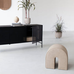 Kristina Dam Studio Curved Pouf in Light Brown Leather in situ with Black Grid Cabinet