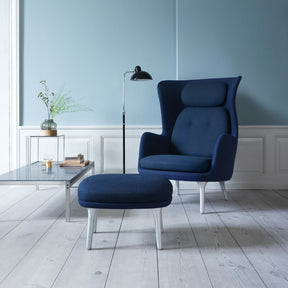 Fritz Hansen Dark Blue Ro Chair and Ottoman in room with Poul Kjaerholm Coffee Tablea and Kasier Idell Floor Lamp