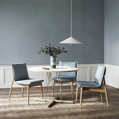 EOOS EO04 Embrace Dining Chairs in room with Embrace dining table, flowers, and pendant light