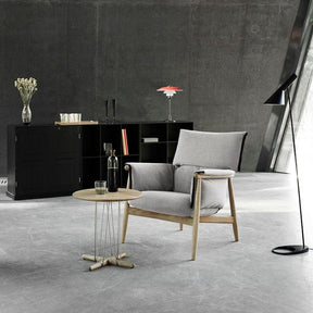 Carl Hansen EOOS lounge table E021 in room with Embrace Lounge chair and Louis Poulsen lamps