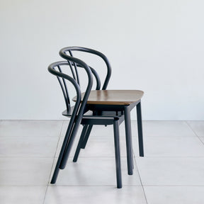 ercol flow chairs by tomoko azumi stacked in walnut and black