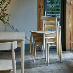 ercol Lara Chairs in Ash stacked beside Luca Table
