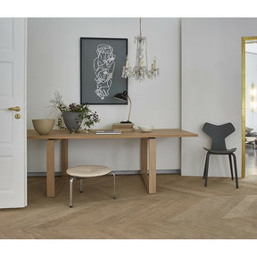 Essay Table in Room with Grand Prix Chair and Poul Kjaerholm Stool Fritz Hansen