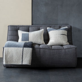 Ethnicraft N701 Sofa Dark Grey in situ with pillows and blanket