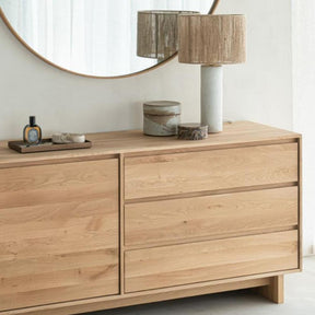 Ethnicraft Oak Wave Dresser in Bedroom with Mirror and Lamp