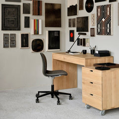 ethnicraft Oak Wave Desk in home office with art