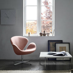 Fritz Hansen Arne Jacobsen Swan Chair Light Pink in room with Poul Kjaerholm Coffee Table