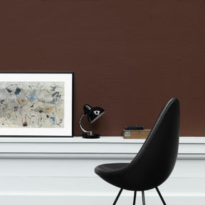 Fritz Hansen Arne Jacobsen Drop Chair Black Leather in room with Art
