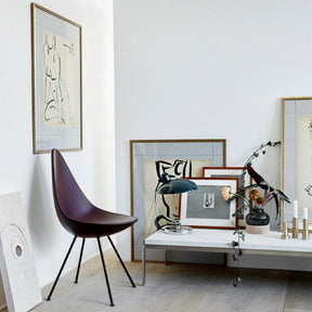 Fritz Hansen Arne Jacobsen Drop Chair styled in room with Art