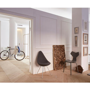 Fritz Hansen Arne Jacobsen Drop Chair in room with Grand Prix Chair and Bicycle