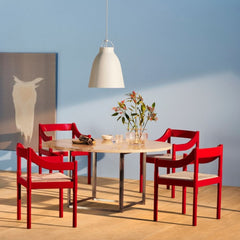 Fritz Hansen Carimate Chairs by Vico Magistretti in room with Poul Kjaerholm Dining Table and Caravaggio Pendant Light