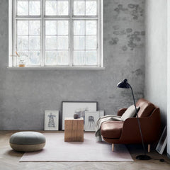 Fritz Hansen Cecilie Manz Pouf in room with Leather Lune Sofa