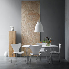 Fritz Hansen White Caravaggio Pendant Light by Cecilie Manz in room with Super Elliptical Table and Series 7 Chairs