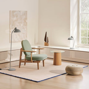 Fritz Hansen Fred Lounge Chair in room with Pouf