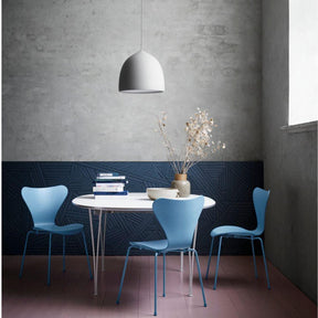 Fritz Hansen Gam Fratesi Suspence Pendant in room with Super Elliptical Table and light blue Series 7 Chairs