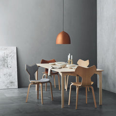 Fritz Hansen Gam Fratesi Suspence Pendant Copper in room with Grand Prix Dining Table and Chairs