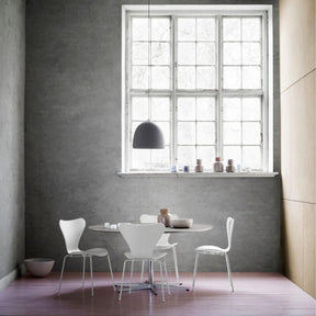 Fritz Hansen Gam Fratesi Suspence Pendant Light Grey in room with white Series 7 Chairs
