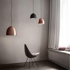 Fritz Hansen Gam Fratesi Suspence Pendants Copper and Black in room with Arne Jacobsen Drop Chair
