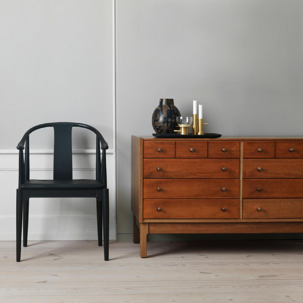 Frit Hansen China Chair by Hans Wegner Black in room with Vintage Chest of Drawers