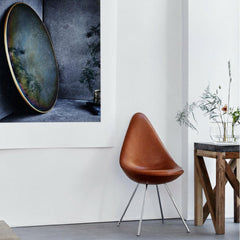 Fritz Hansen Leather Drop Chair in room with Ikebana Vase and Objects Mirror