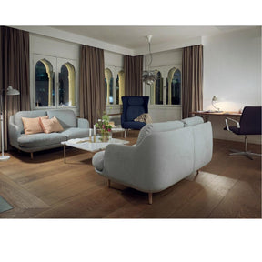 Fritz Hansen Lune Sofas by Jaime Hayon in room with Poul Kjaerholm Coffee Table, Ro Chair, and Oxford Chair