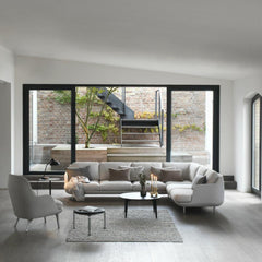 Fritz Hansen Fri Chair in room with Lune Corner Sectional Sofa by Jaime Hayon